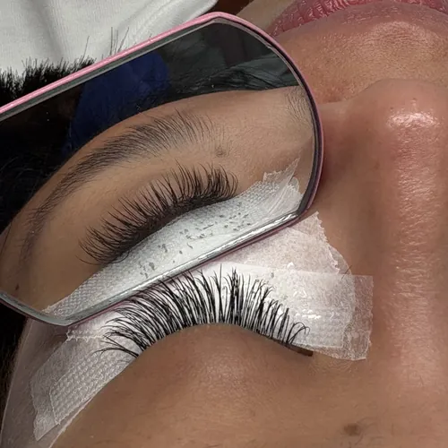 A finished lash set checked in a mirror at iLashas